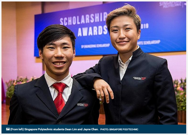 Two smiling students in dark blazers pose at a Singapore Polytechnic Scholarship Awards event.